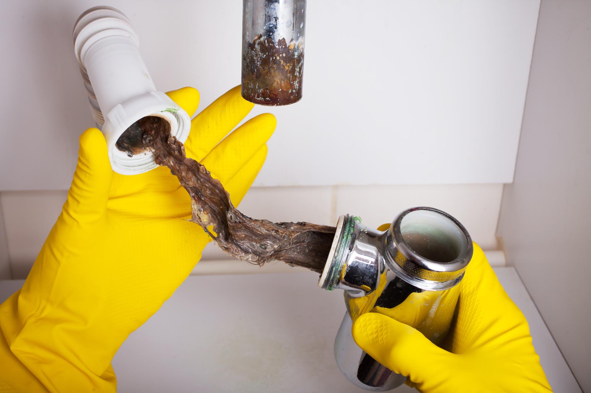Washbasin's siphon cleaning in a bathroom